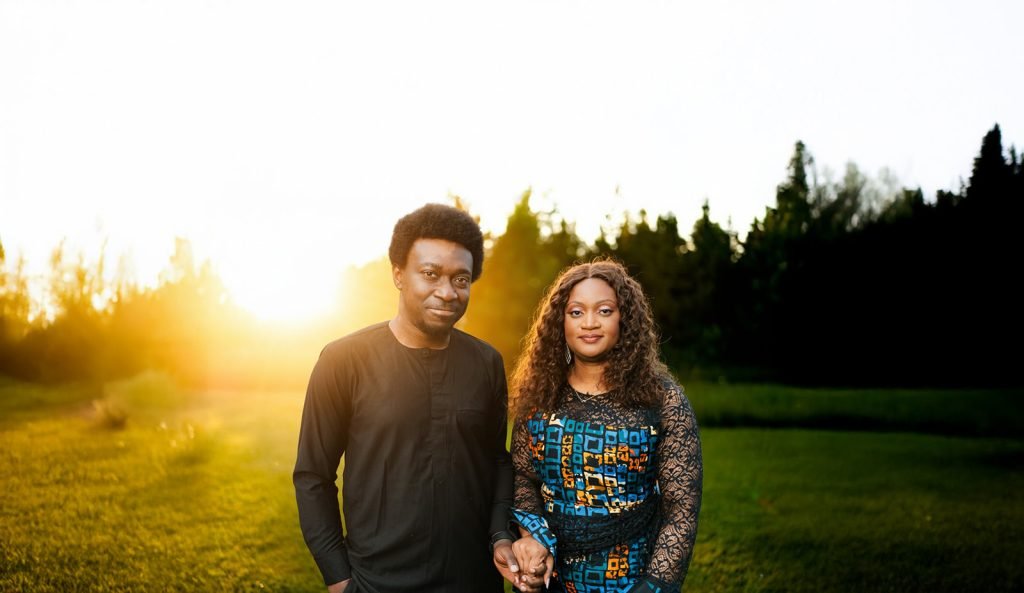 Couple holding hands at sunset.